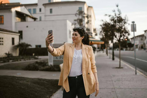 Woman taking a selfie in the city during solo travels