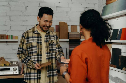 Salesman showing wood samples to a client during a product consultation.