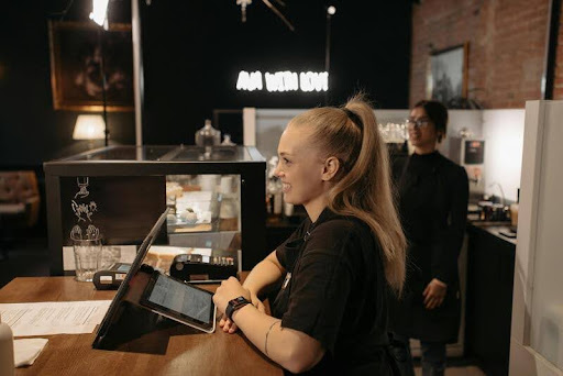 Salesperson smiling behind a counter