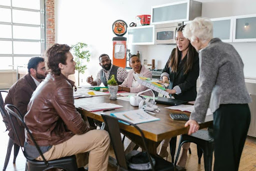 Group of colleagues having a meeting around a table