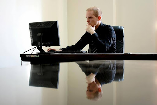 Man working on a laptop in a modern office setting