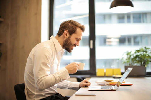 Man focused on laptop while working indoors
