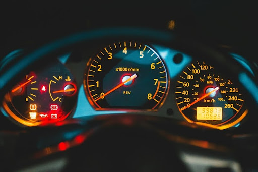 Car dashboard with illuminated check engine light