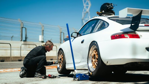 Mechanic adjusting car tires in an auto repair shop