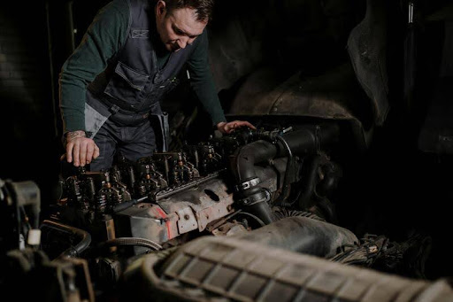 Mechanic working on a truck engine in an auto repair shop