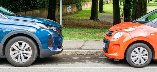 Electric car and hybrid vehicle parked side by side
