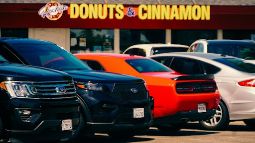 Row of parked cars in a city street.
