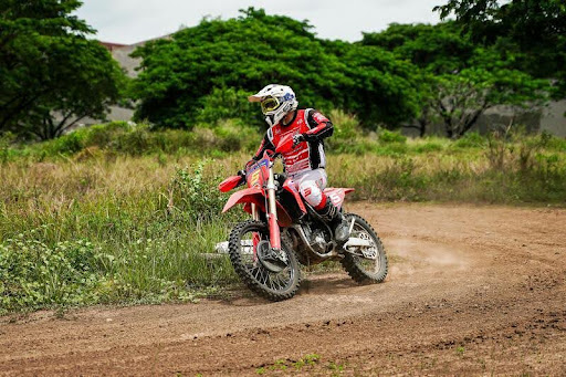 Man riding a dirt bike on a rugged trail