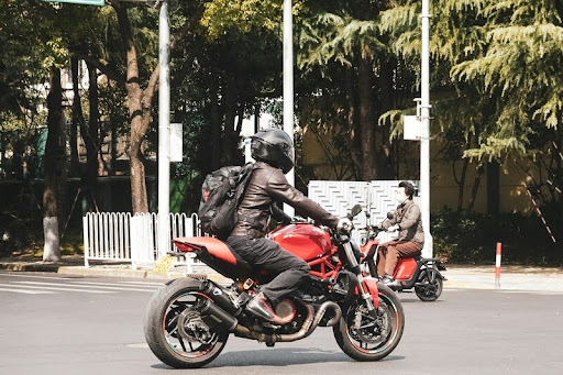 Man riding a motorcycle through a busy city street
