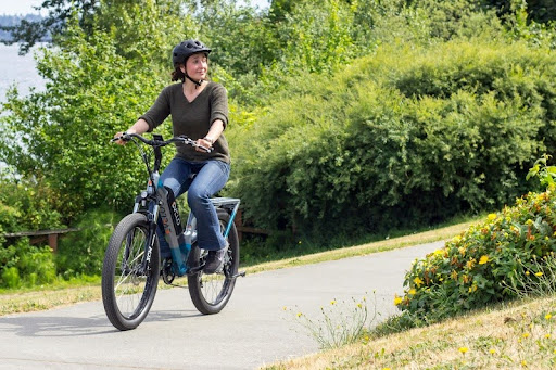 Woman riding an electric bike on a city street