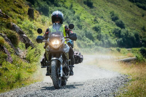 Person riding a touring motorcycle on a scenic U.S. highway