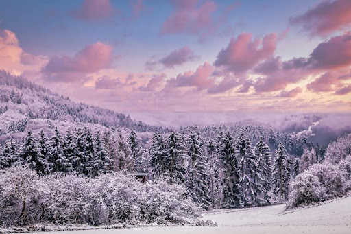Snow-covered mountains at sunset in winter