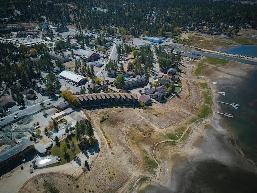 City nestled near snow-covered mountains at sunset