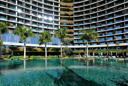 Eco-friendly hotel surrounded by trees with a swimming pool in view