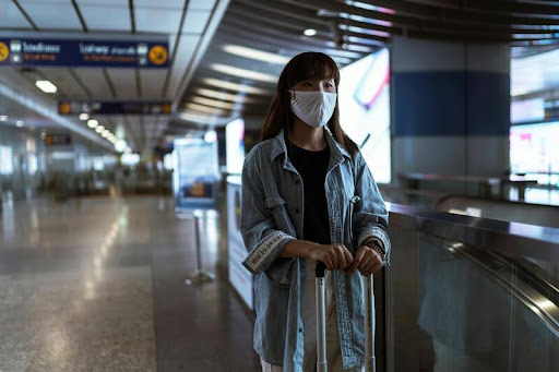 Woman waiting with luggage at an airport terminal