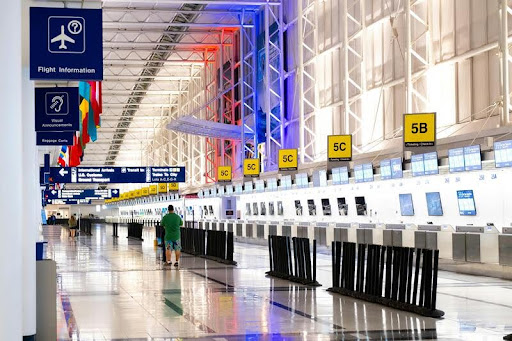 Modern airport terminal with travelers walking through the concourse