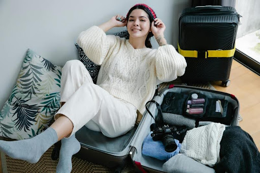 Woman packing clothes into a suitcase for a trip