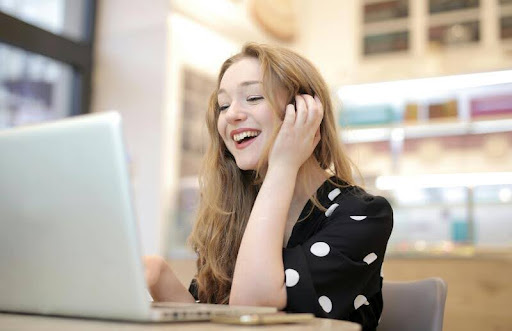 Woman using a laptop indoors, focused on screen
