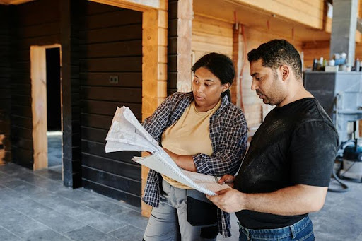 Man and woman reviewing a construction plan together.