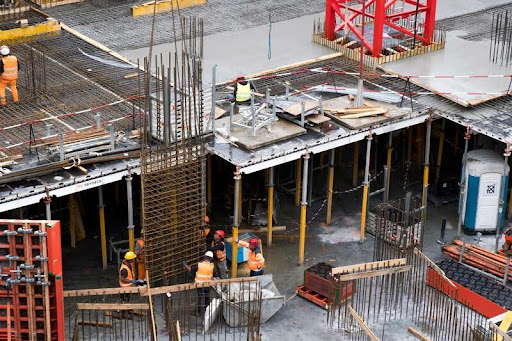 Workers assembling modular units at a construction site
