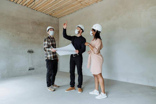 People inspecting a new construction site for quality and safety
