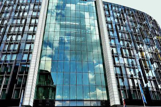 Grey and black high-rise commercial building under a clear sky