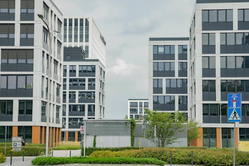 Grey multi-storey commercial buildings under daylight.