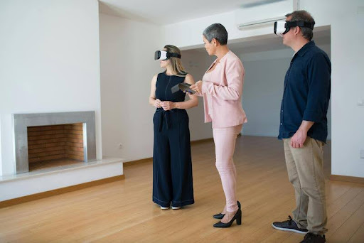 Real estate agent guiding homebuyers using virtual reality goggles