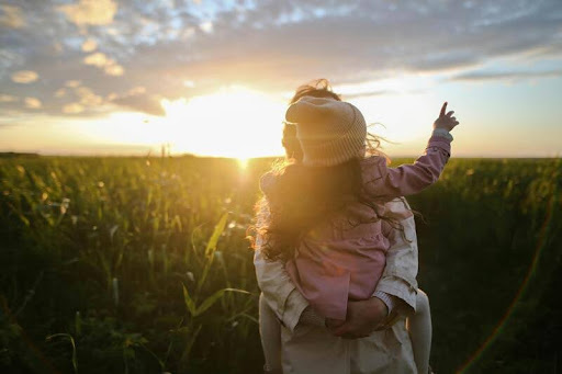 Woman carrying her child while walking outdoors