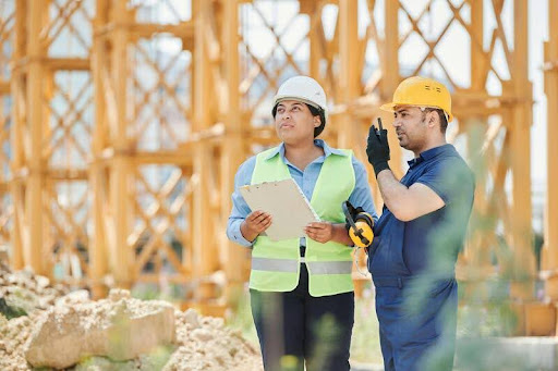 Construction worker standing at a job site wearing safety gear
