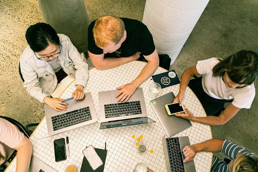 Group of people sitting around a table in a meeting