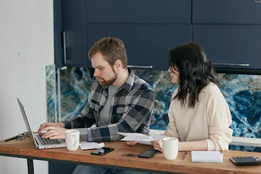 Man and woman working together at a desk in a modern office.