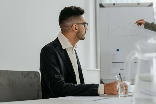 Man sitting attentively during a financial planning presentation.