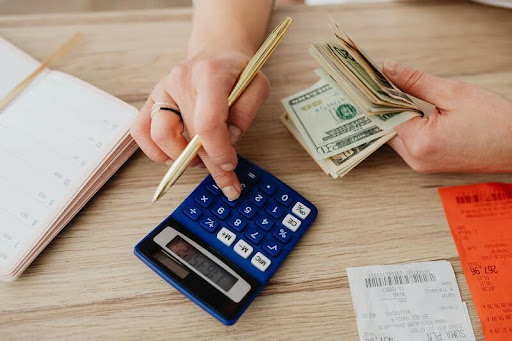 Person counting cash bills at a table