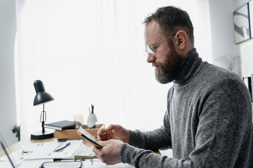 Businessman checking phone for financial updates