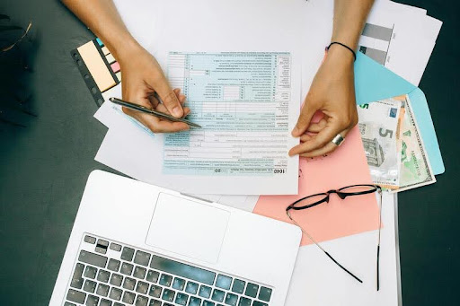 Person writing notes on paper at a desk