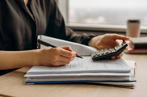 Woman using a calculator at her desk