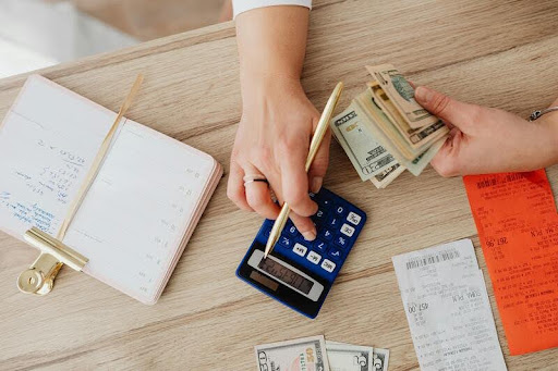 Person counting cash at a table