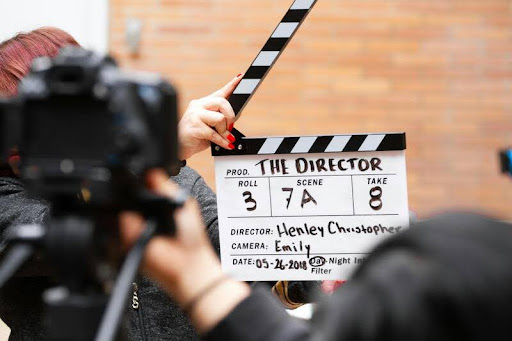 Man holding a clapper board on a film set