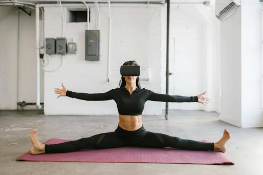 Woman practicing yoga while wearing virtual reality goggles.
