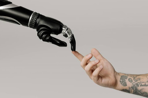 Bionic hand and human hand touching fingers