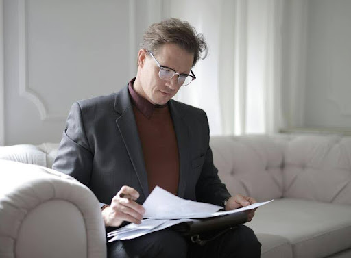 Man reading financial documents at a desk