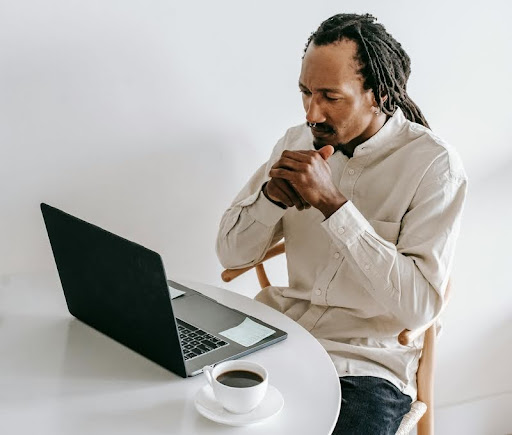 Man sitting with a laptop, studying algorithms online.