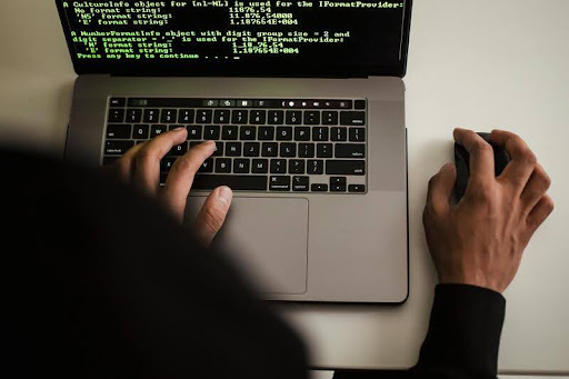 AI developer working on a computer screen displaying lines of code and data
