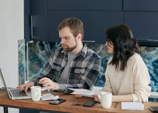Man and woman working together on a laptop.