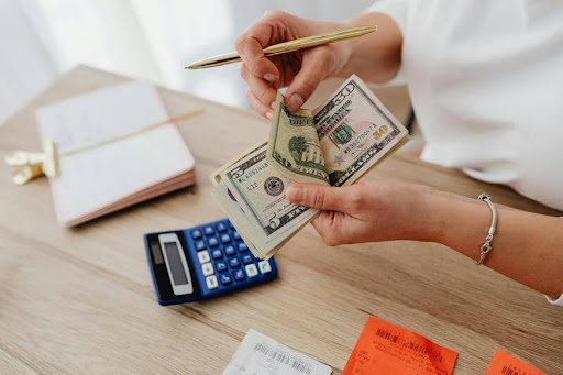 Woman counting cash at a desk