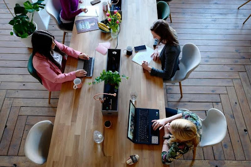 Group of women collaborating at a shared office workspace