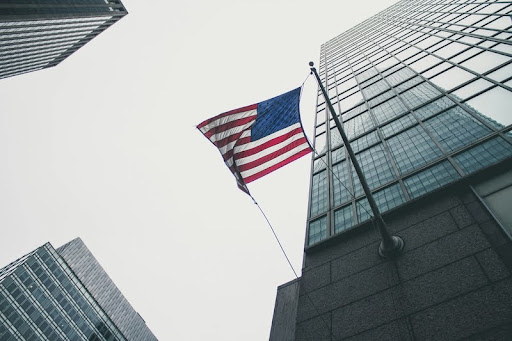 American flag draped on a tall skyscraper