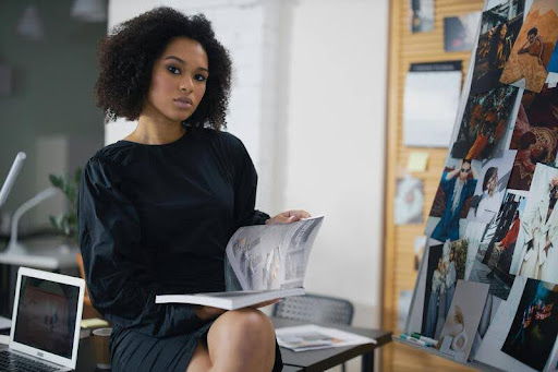 Woman sitting at a desk in an office, reviewing financial documents