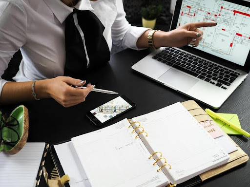 Man designing a house blueprint at his office desk